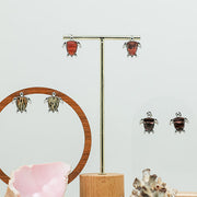 Three pairs of Mini Silver Turtles on stands on a white background with two shells at the bottom of the image.