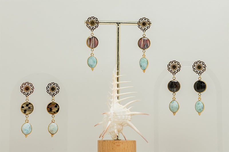 Three pairs of Larimar Mandala Drop earrings on a white background with a white shell at the bottom of the image.  