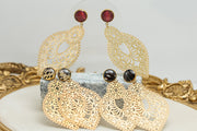 Three pairs of Golden Hour Lace Earrings on black and white marble on a white background with a gold frame.