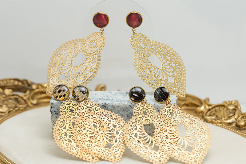Three pairs of Golden Hour Lace Earrings on black and white marble on a white background with a gold frame.