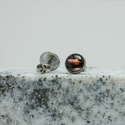 Small Studs on black and white marble on a white background.