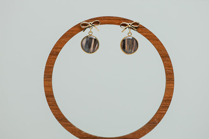 Mini Bow Posts on a circular wooden stand on a white background.  