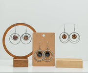 Three pairs of Large Silver Double Loops on stands on a white background. 