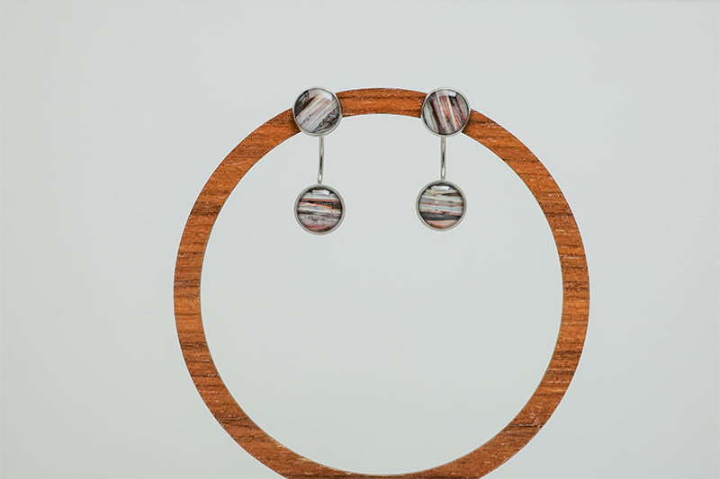 Ear Jacket Post Earrings on a circular wooden stand on a white background.  