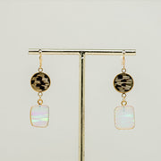 A pair of Opal Slice Earrings on a gold rod stand on a white background. 