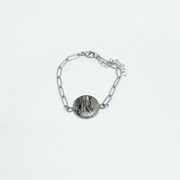 A Silver Paperclip Bracelet on a white background.