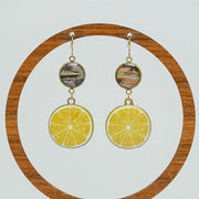 Coastal Capri Earrings on a circular wooden stand on a white background. 