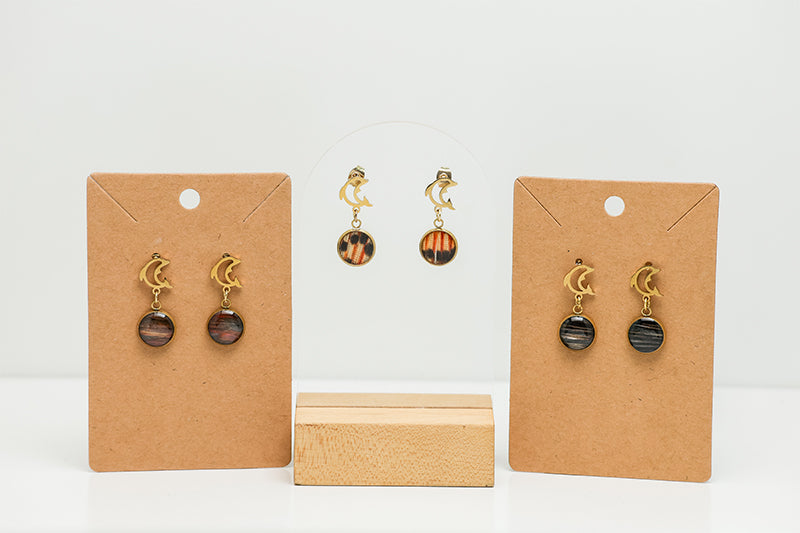 Three pairs of Mini Dolphin Posts on stands on a white background.  