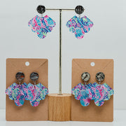 Three pairs of Preppy Scalloped Earrings on stands  on a white background. 