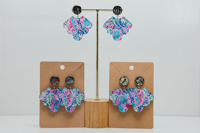 Three pairs of Preppy Scalloped Earrings on stands  on a white background. 