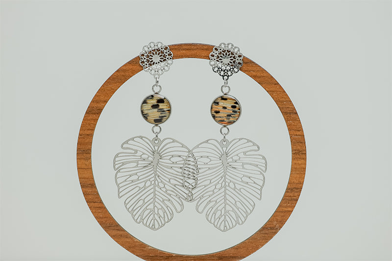 Monstera Leaf Mandala Drops on a circular wooden stand on a white background.  