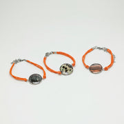 Three Orange Cord Bracelet on a white background. 