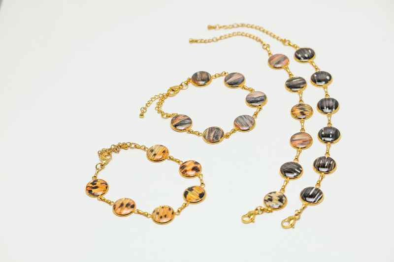 Four Gold Tennis Bracelets on a white background - fins are either all tail, all pectoral, all pelvic or mixed. 