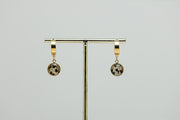 Golden Huggies on a gold stand on a white background.