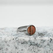 A Silver Adjustable Ring on black and white marble on a white background.