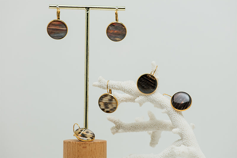 Three pairs of French Hook Earrings on a white background with white coral .
