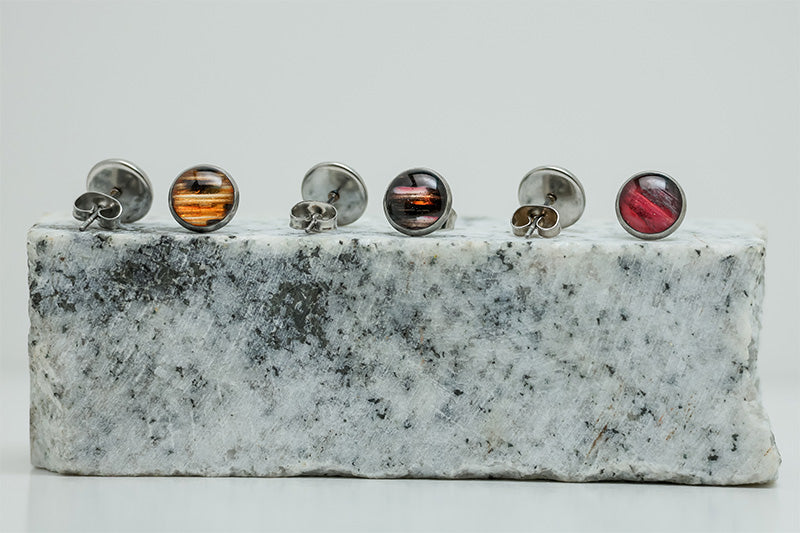 Three pairs of Small Studs on black and white marble on a white background.
