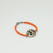 A Orange Cord Bracelet on a white background. 