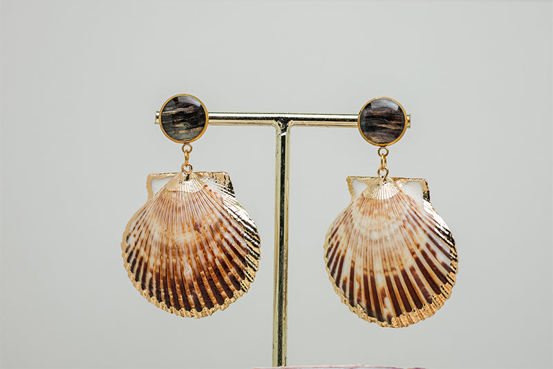 Scallop Shell Statement Earrings on a gold stand on a white background.