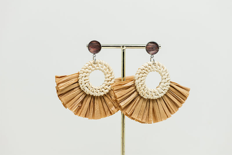 Boho Rattan Statement Earrings on a gold stand on a white background.