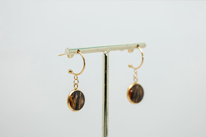 Gold Open Hoop Posts on a gold stand on a white background.