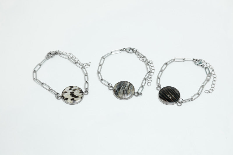 Three Silver Paperclip Bracelets on a white background.