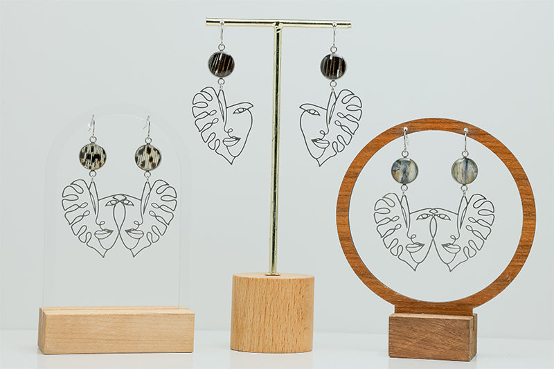 Three pairs of Into the Jungle Earrings on stands on a white background.  