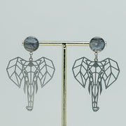 Geometric Elephant Earrings on a gold stand on a white background.