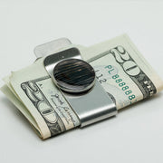 Silver Money Clip on a $20 bill on a white background. 