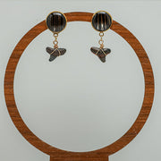 Shark Tooth Gold Posts on a wooden circular stand on a white background. 