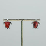 Mini Silver Turtle earrings on a stand on a white background.