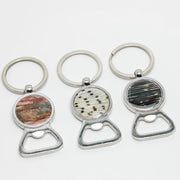 Three silver Bottle Opener Keychain rings on a white background.
