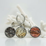 Three silver Keychain rings on white coral on a white background.