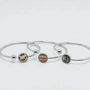 Three Silver Cuffs on a white background. 