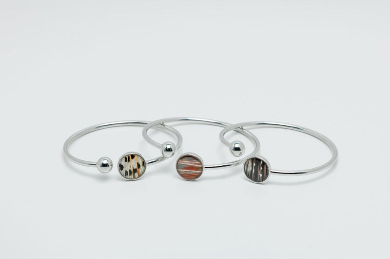 Three Silver Cuffs on a white background. 