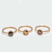 Three Mini Rose Gold Rings on a white background.