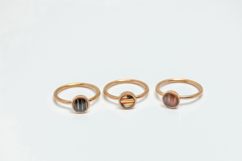 Three Mini Rose Gold Rings on a white background.