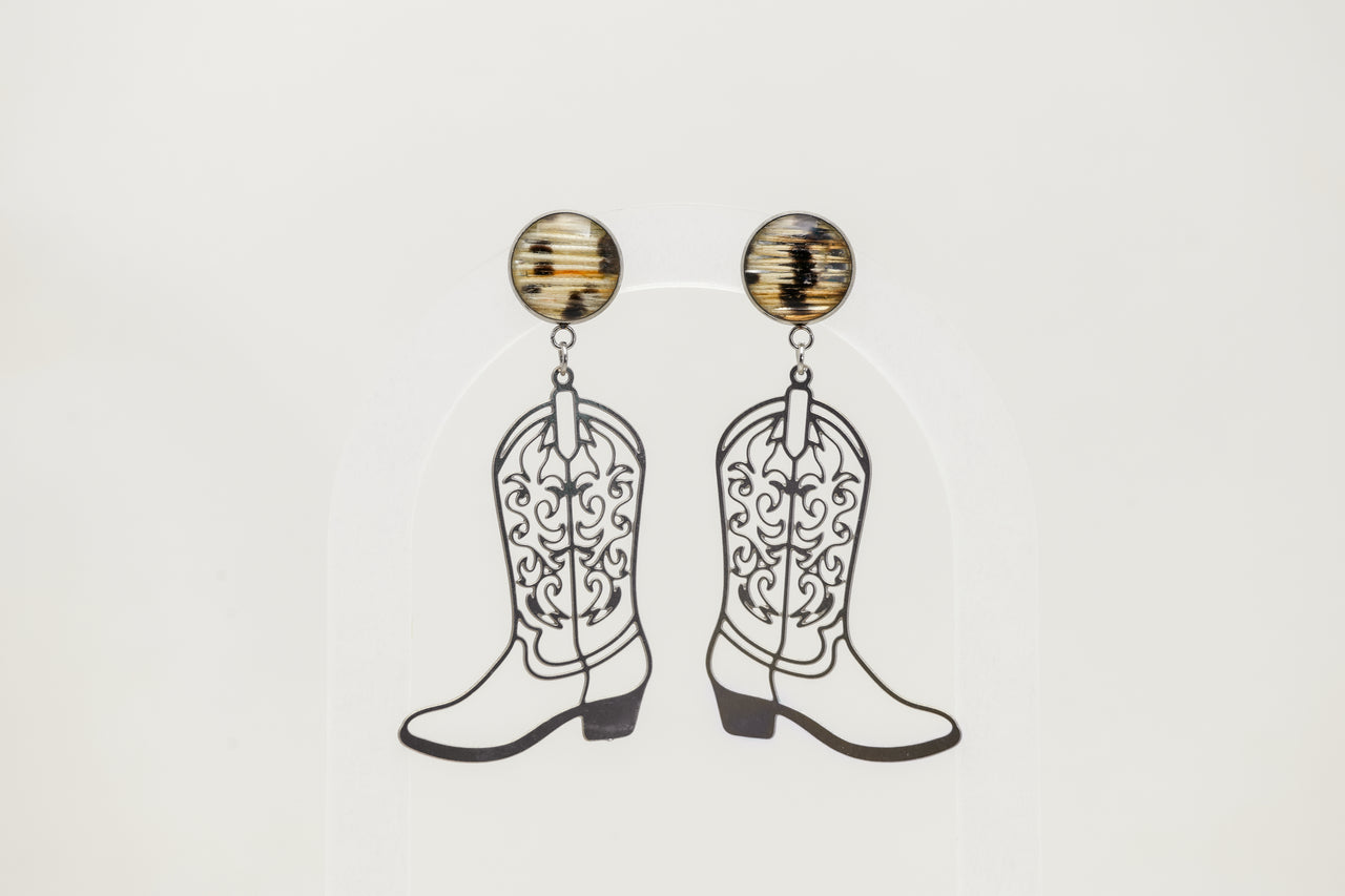 Cowboy boot lionfish earrings on a light gray background