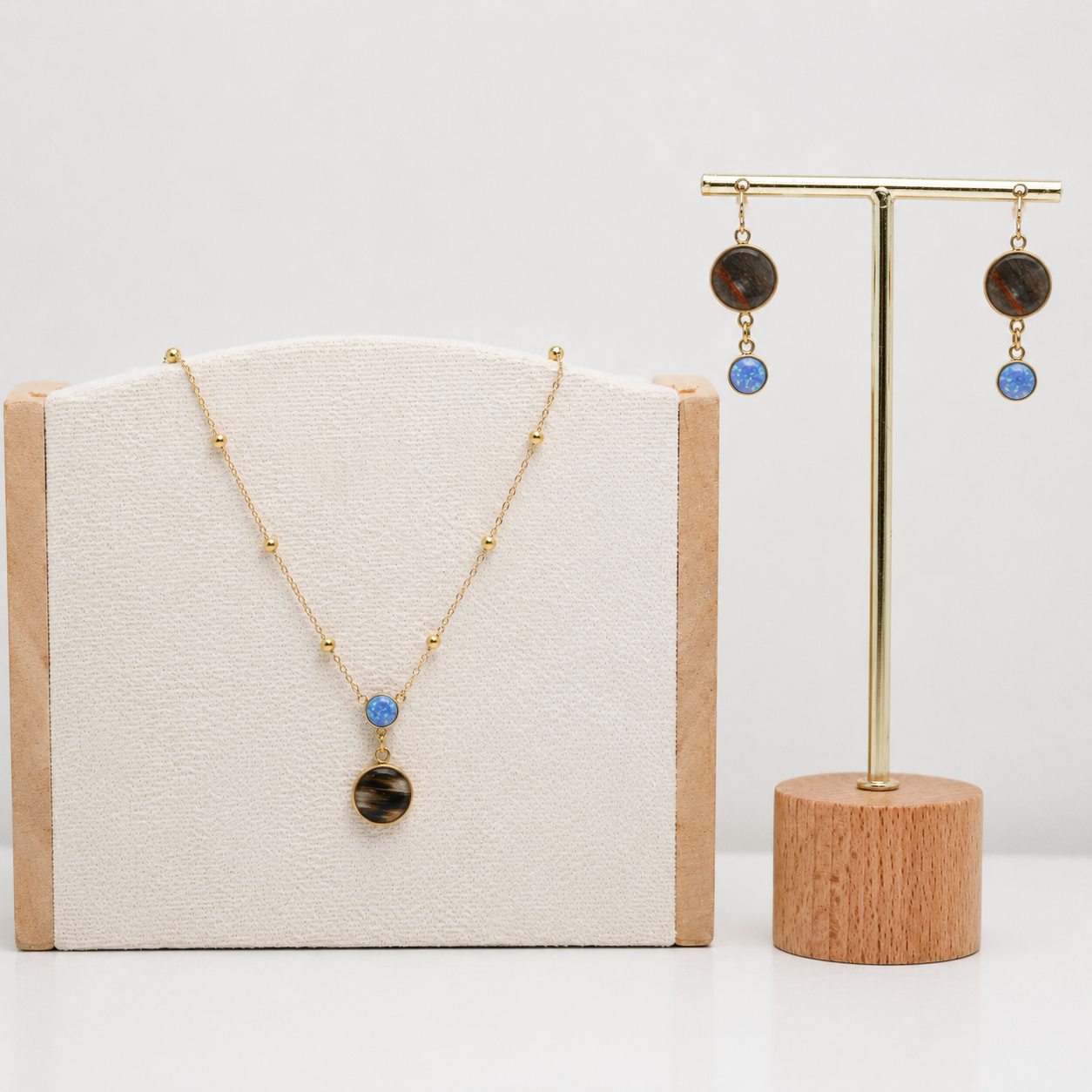 Lionfish Necklace and earrings with blue opals on display with a neutral background