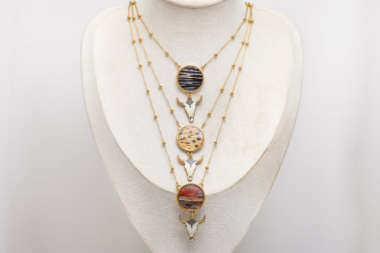 Necklace with various lionfish pendants on a white mannequin bust