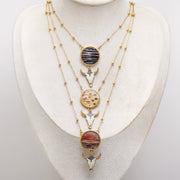 Necklace with various lionfish pendants on a white mannequin bust