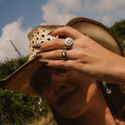Person wearing a wide-brimmed hat with a scenic background