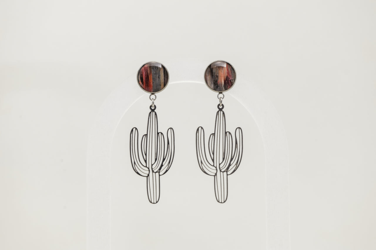 Cactus-shaped earrings with round brown lionfish fins on a light gray background