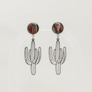 Cactus-shaped earrings with round brown lionfish fins on a light gray background