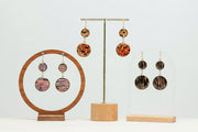 Gold stainless steel dangle earrings with lionfish pattern resin charms on display stand