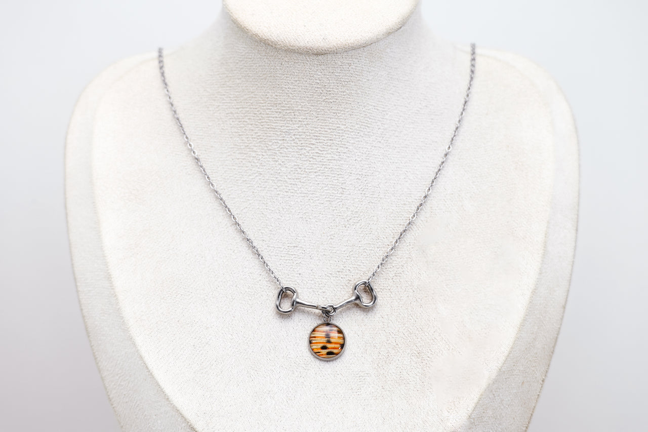 Necklace with a lionfish pendant on a mannequin bust against a white background