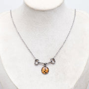 Necklace with a lionfish pendant on a mannequin bust against a white background