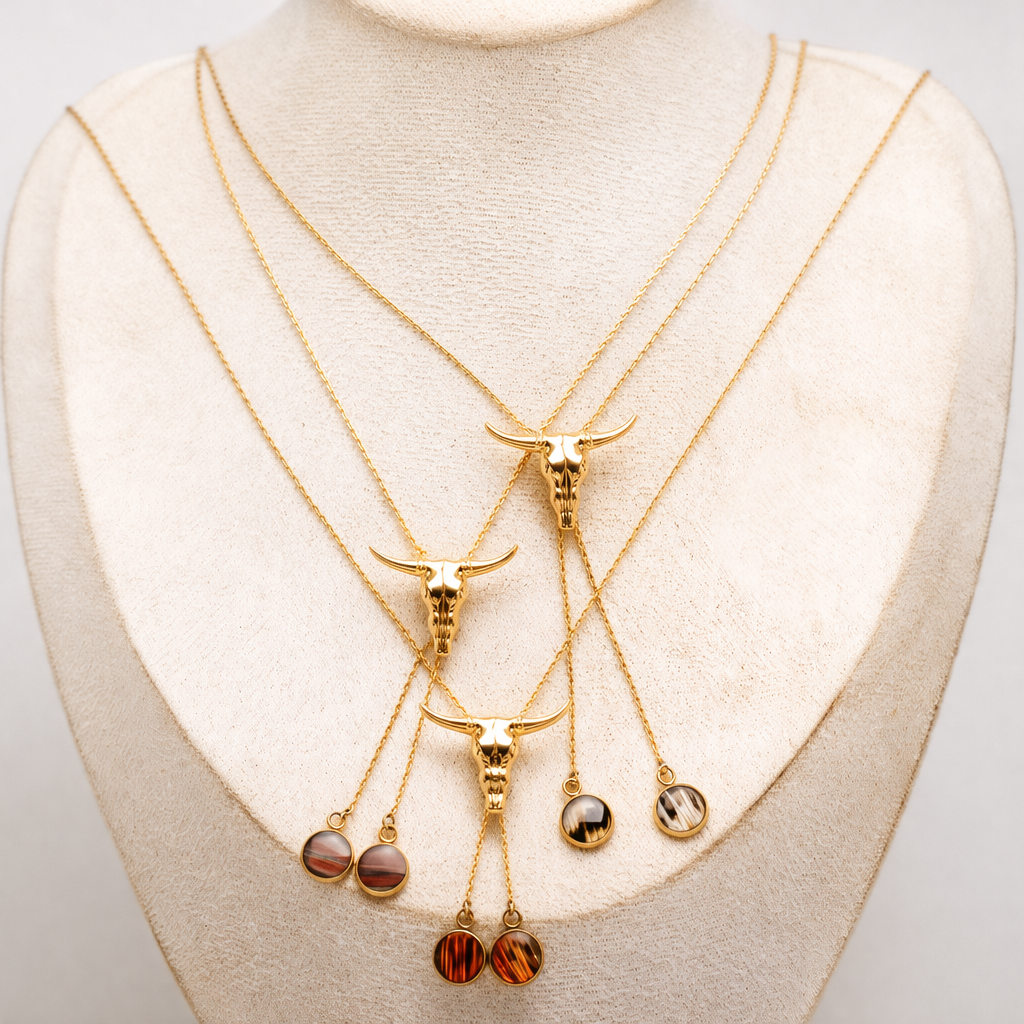 Set of gold necklaces with pendant lionfish fin drops on a mannequin bust.