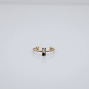 Gold ring with a small vertical bar on a white background