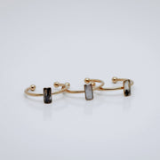 Three Gold rings with a small vertical bar on a white background